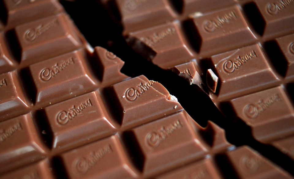 Close-up photo of a broken Cadbury Dairy Milk chocolate bar.