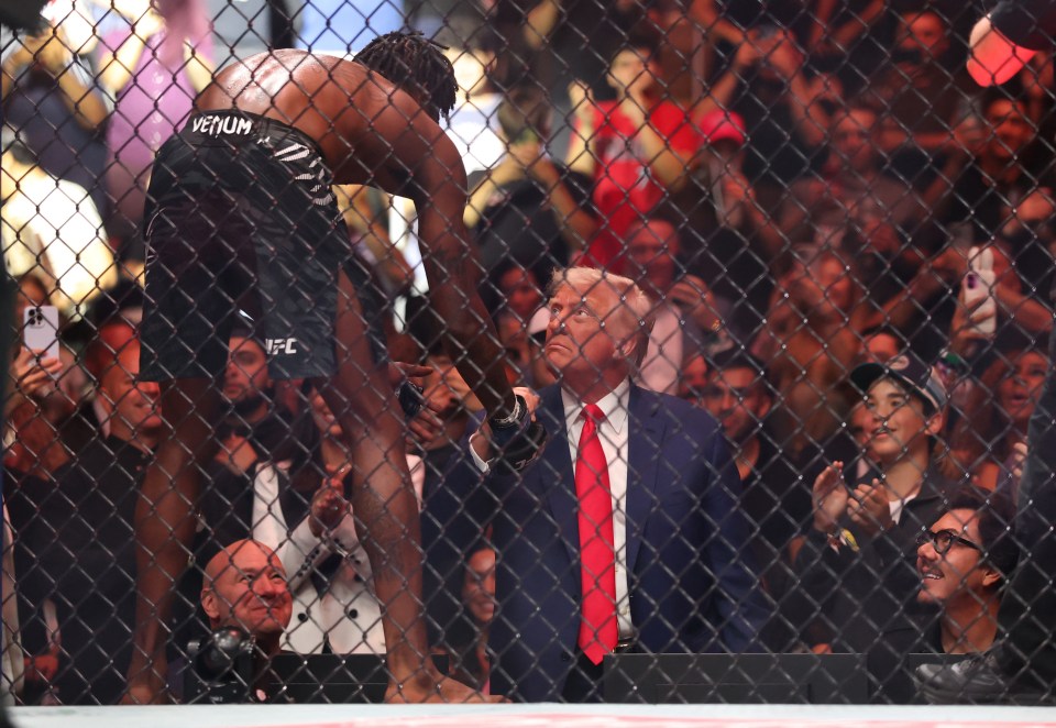Kevin Holland shaking hands with Donald Trump at a UFC event.