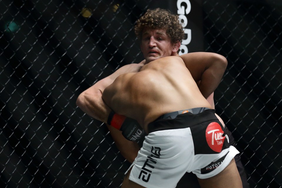 Ben Askren (back) fighting Agilan Thani in a welterweight bout.