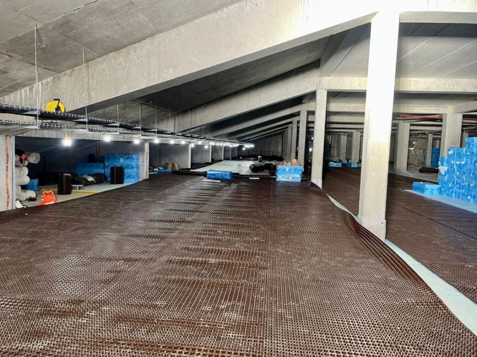 Crystal Palace stadium redevelopment: interior view of stadium under construction, showing drainage system installation.