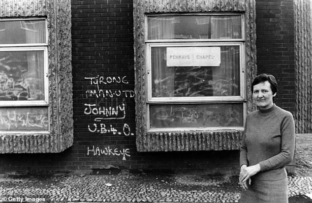 United Reform minister Patricia Parrish looks at some of the graffiti on the walls at her chapel on the Penrhys Estate -- March, 1986