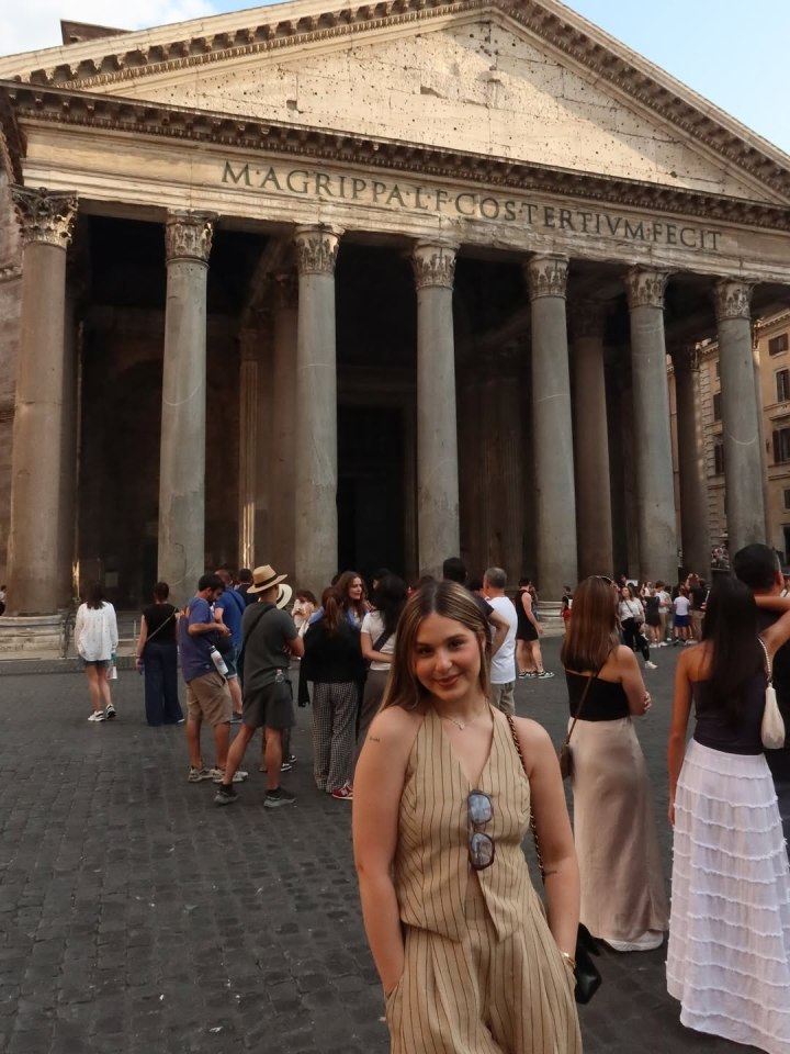 Woman in beige pinstripe jumpsuit in front of the Pantheon.