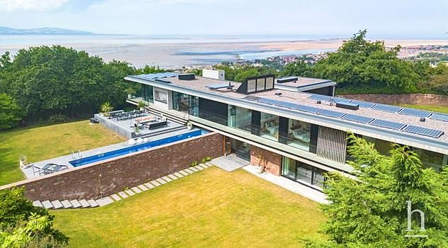 The stunning house sits in a prominent location on the edge of the sandstone outcrop of the Wirral Peninsula