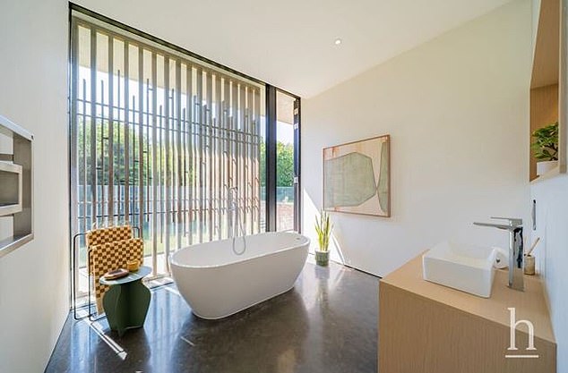 The ground floor bedroom also features a quaint en suite bathroom with a sleek bathtub