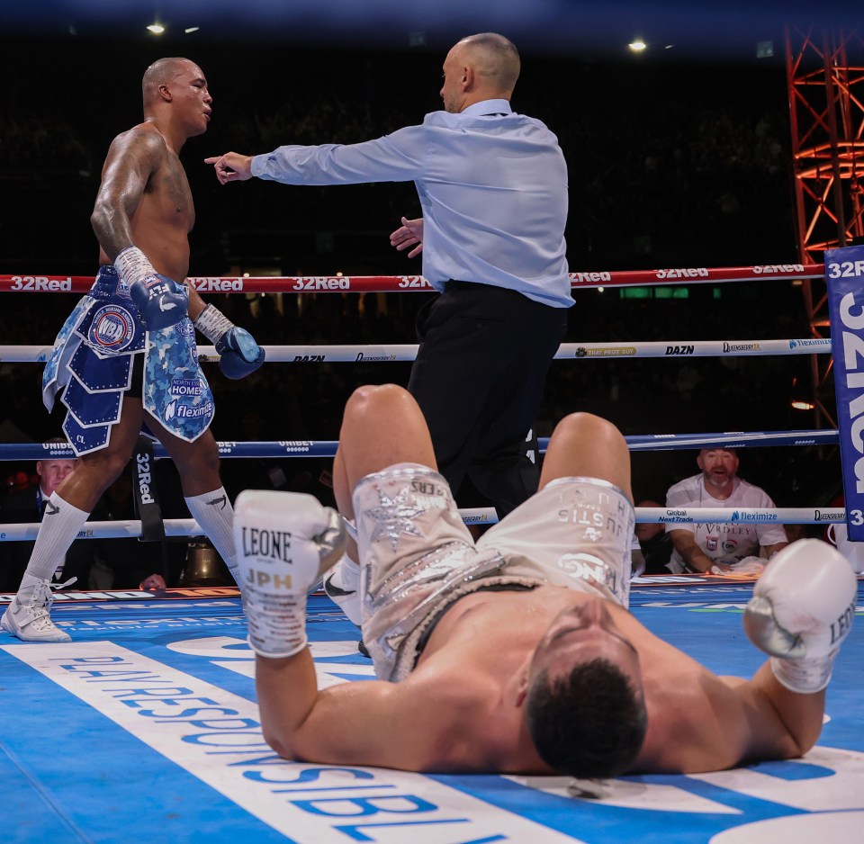 Referee counting down a boxer after a knockout.