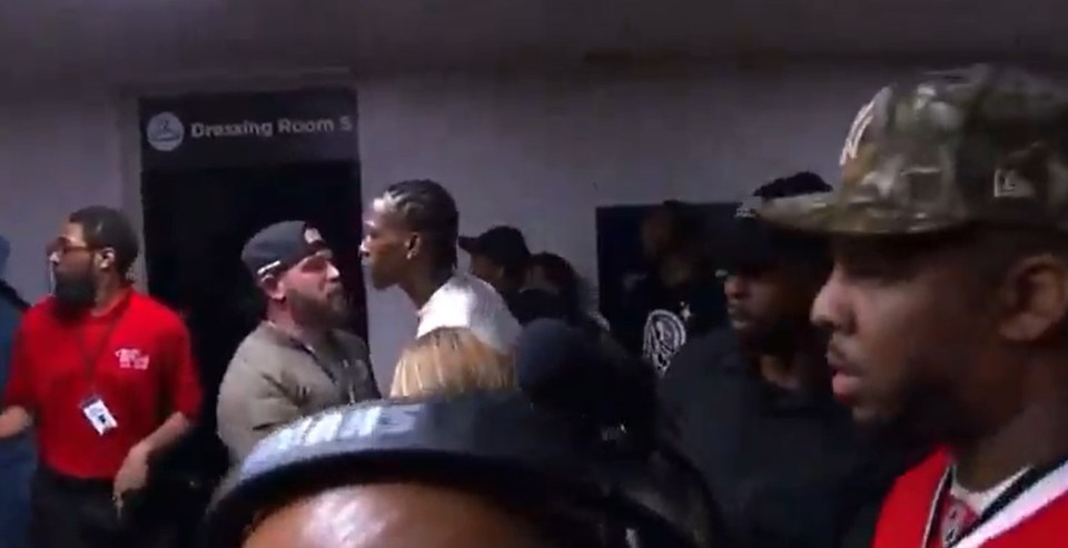 Boxer Keyshawn Davis escorted by police after a backstage brawl.