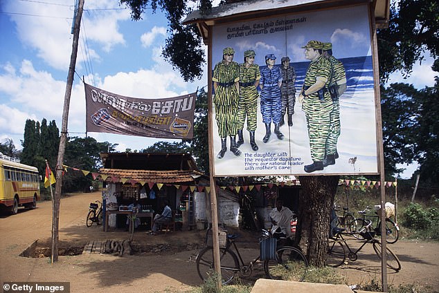 The Sri Lankan faces claims he 'enlisted children under the age of 15' to the separatist group (pictured: Stock photo of a Tamil Tigers recruitment poster)