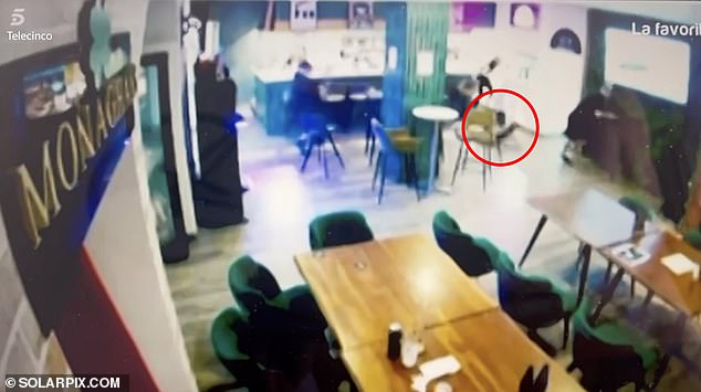 Video broadcast on Spanish TV showed the gunman (centre) storm through Ross Monaghan's bar and take aim at the gangster