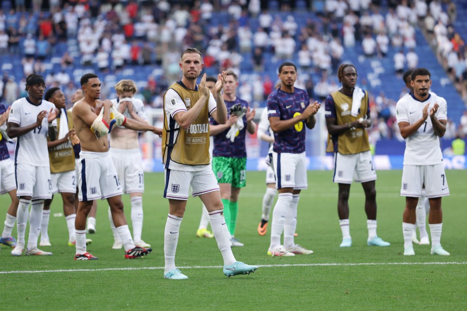 Jordan Henderson of England applauding fans after a soccer match.