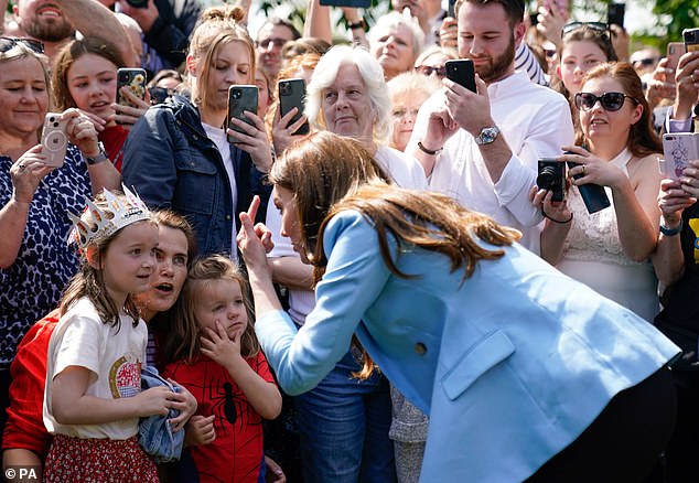 The Princess of Wales speaks to a group of children during a walkabout on the Long Walk near Windsor Castle in May 2023