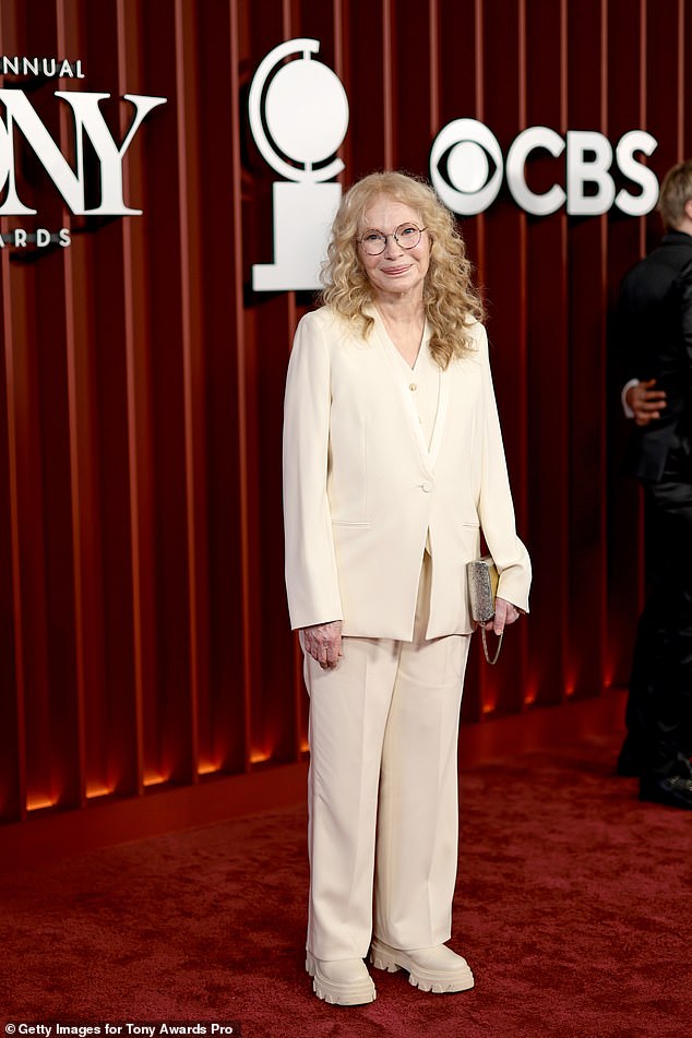 Mia Farrow chose a cream colored suit with platform boots in the same color
