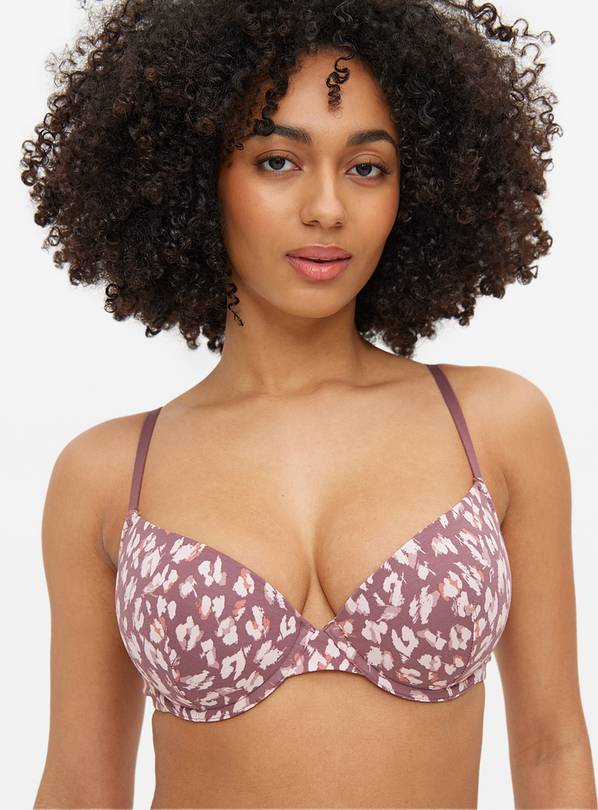 Woman wearing a mauve leopard-print bra.