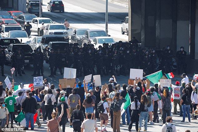 Extraordinary vision shows at least 2,000 protesters as they commandeered both sides of the road, grinding traffic to a complete halt as they march down the streets waving flags and holding signs high above their heads