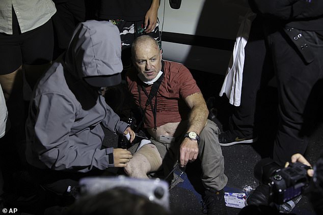 Mr Stern said protestors helped him to a nearby kerb after the impact, where he was assisted by medics who cut a hole in his trousers to reveal a 'giant hole' in his leg