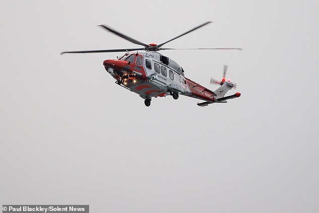 A coastguard helicopter was called to the scene and winched rescue teams down to assist