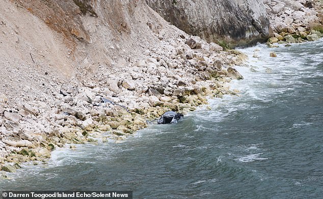 The car landed at the bottom of the cliff, where it was half-submerged with its bonnet and roof crumpled
