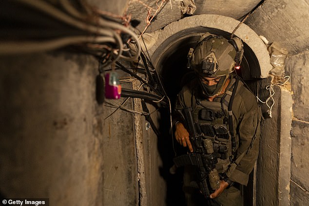 An Israeli soldier guards at a tunnel, where the Israeli army believes to be Hamas leaders underground infrastructure while escorting members of the press near the Gaza European Hospital near Khan Yunis on June 8, 2025 in Khan Yunis, Gaza