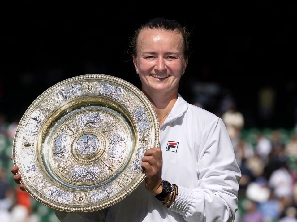 Barbora Krejcikova holding the Wimbledon Ladies' Singles trophy.