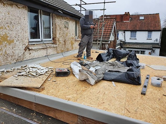 Pictured: A builder constructs the work, which Ms Grant claims has destroyed her house