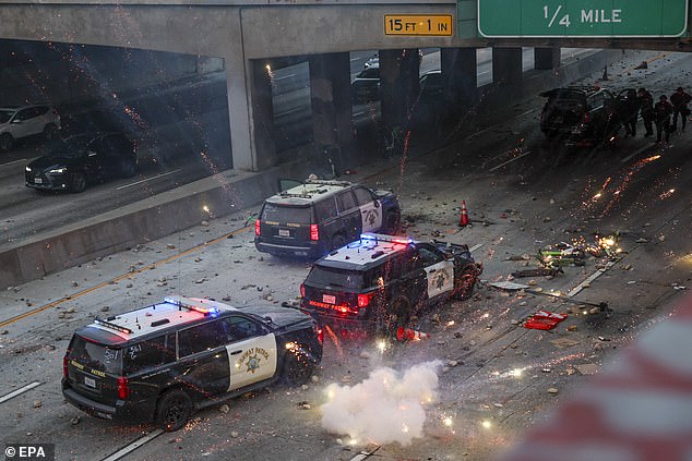 LA police officers were forced to take cover after their cars were attacked during wild and vicious scenes on Sunday