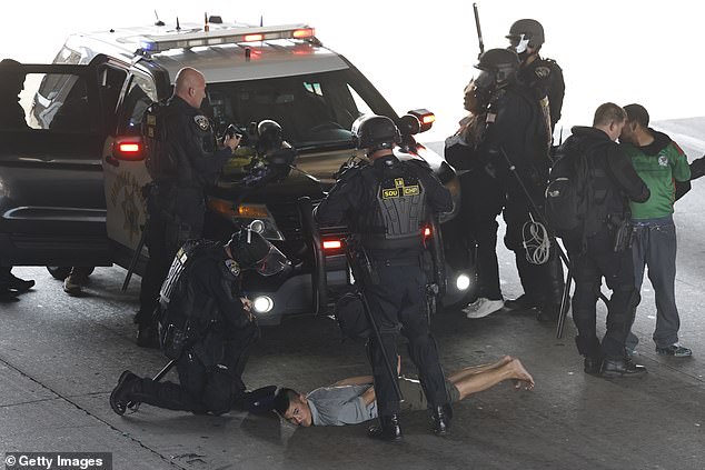 Officers made at least 60 arrests on Sunday, officials said
