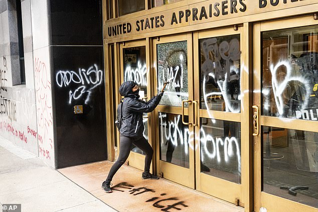 Protests and vandalism spread to San Francisco on Sunday (pictured), with the ICE office targeted