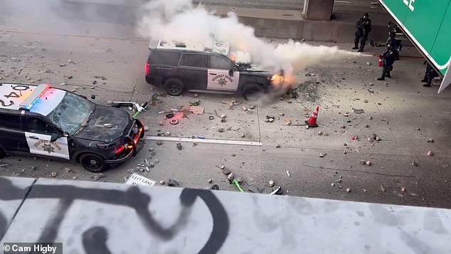 Extraordinary footage showed a small contingent of Los Angeles highway patrol officers under siege by protesters who had seized control of the overpass above them.