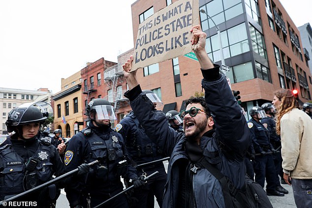 Demonstrators take part in a protest against immigration sweeps at the ICE building in San Francisco