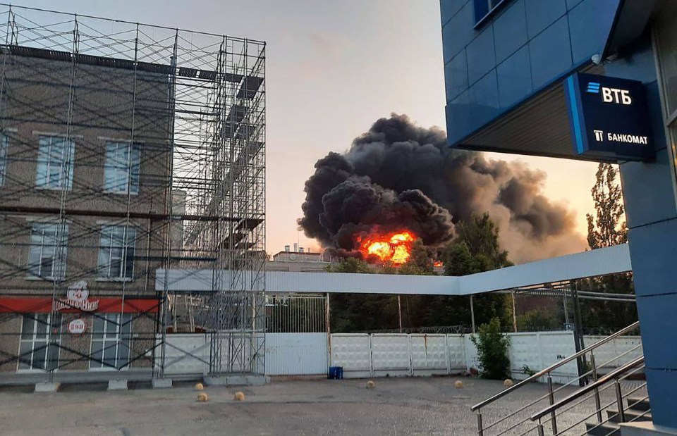 Large fire and black smoke billowing from a building.