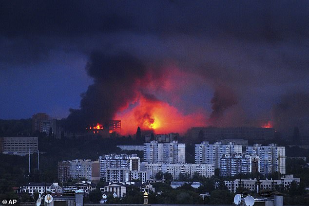 Fire and smoke rise from the site where a Russian missile struck a residential area in Ukraine