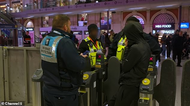 A passenger is caught without a ticket by revenue protection officers at the gates at Waterloo