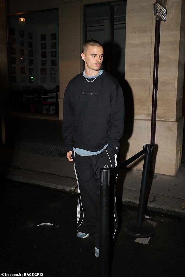Romeo cut a casual figure for the outing, opting for a black sweater teamed with dark tracksuit bottoms and blue trainers