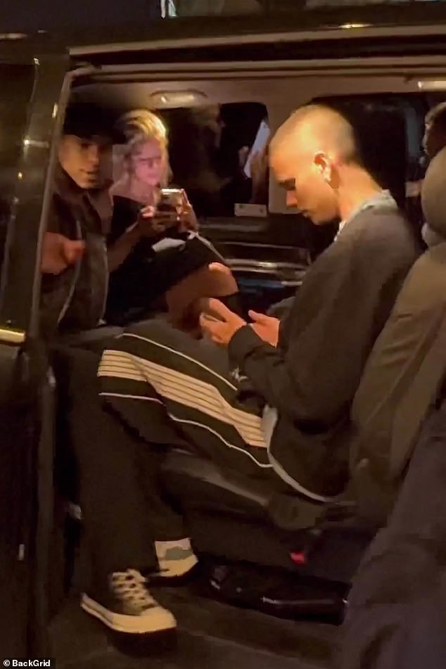 The pair kept their heads down and busied themselves on their phones as they sat in the car