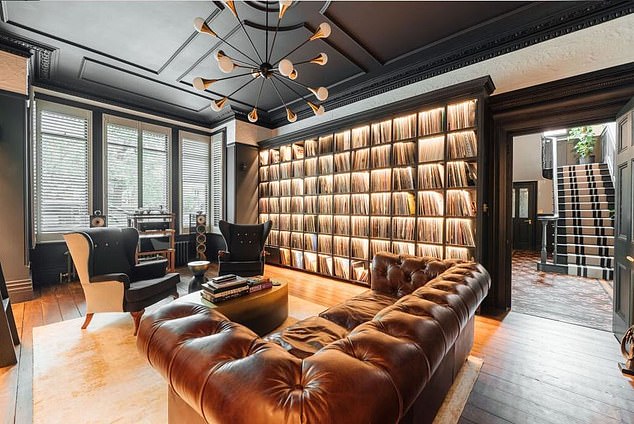 Spoony's 'vinyl room' (pictured) would be a 'sophisticated and elegant' library - describing it as 'a striking and atmospheric space designed for quiet retreat or focused work'