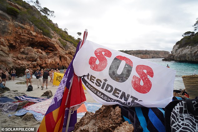 Others held up smaller banners with the message: 'SOS Residents' on them