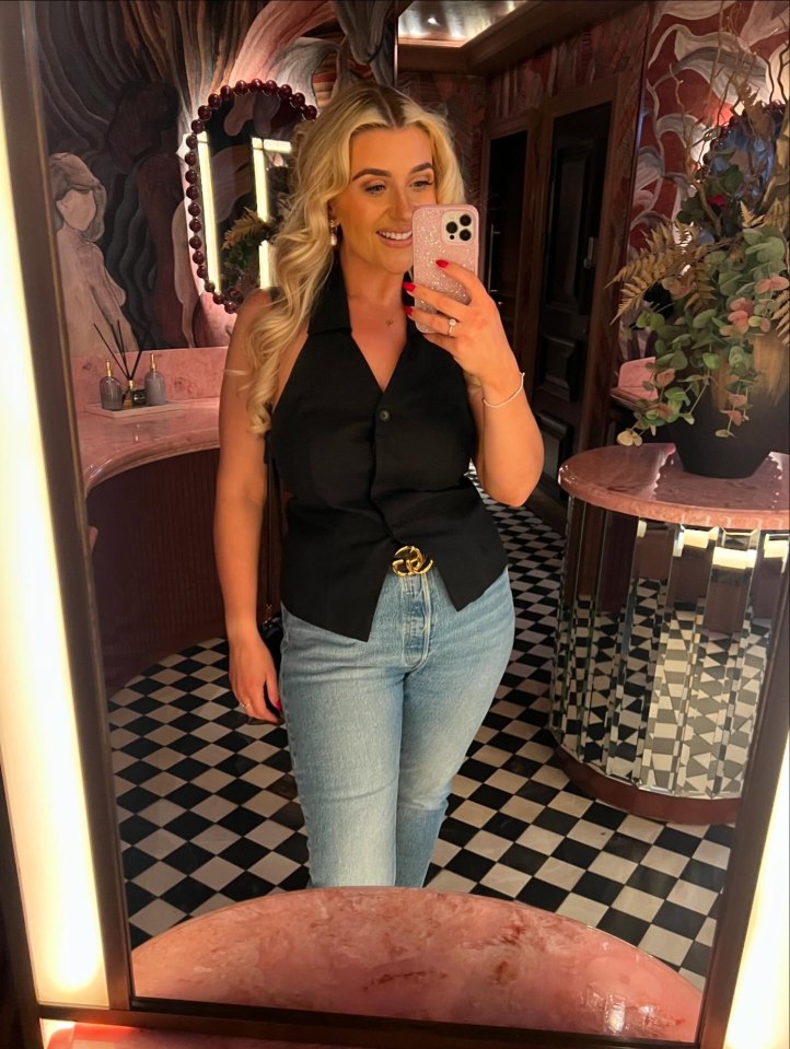 Woman taking a selfie in a stylish restroom.