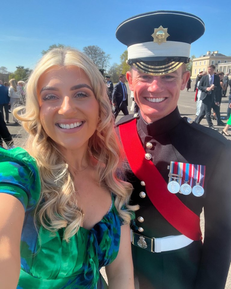Woman in green dress with a man in military uniform.