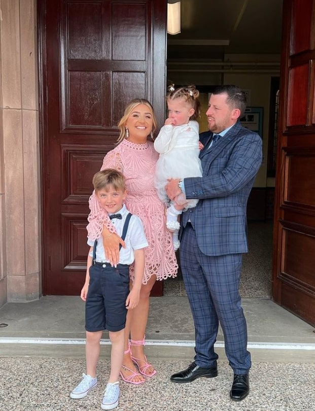 Family portrait in front of a church.