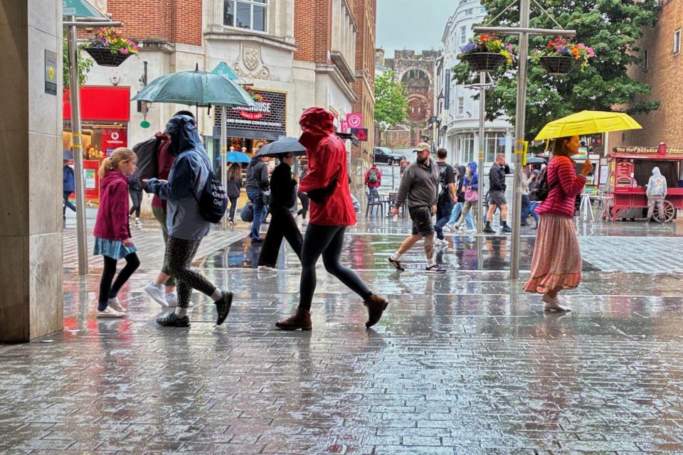 People walking in the rain in Exeter, Devon.