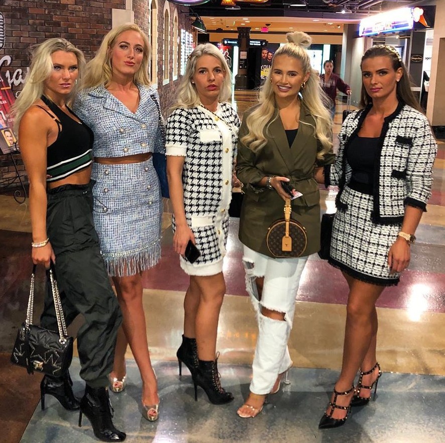 Five women posing for a photo.