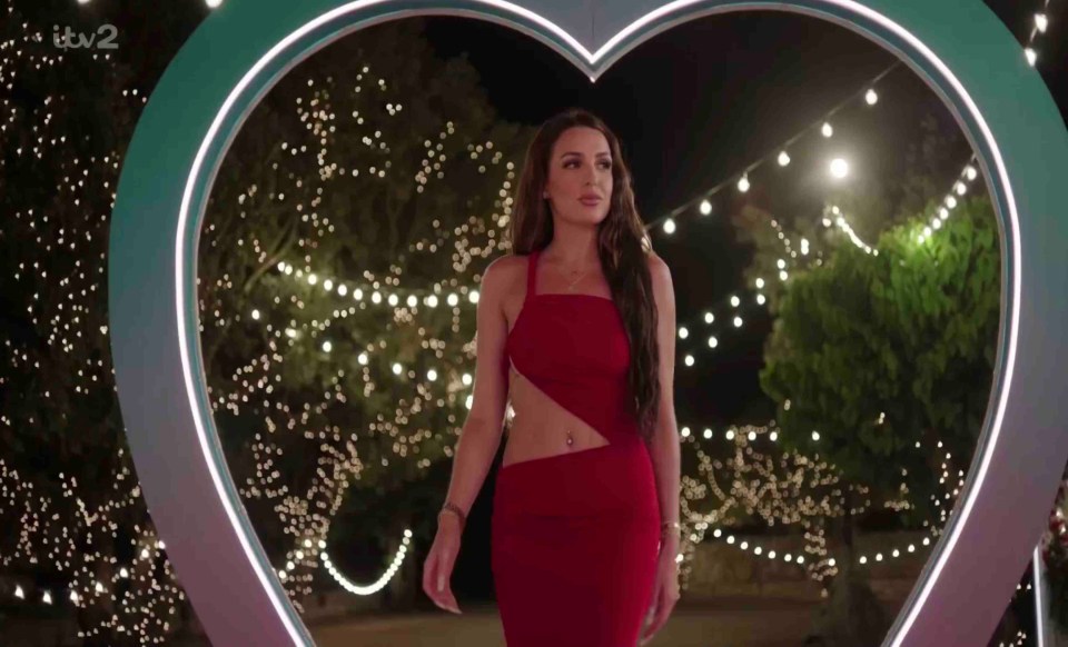 Maya Jama in a red dress at the Love Island villa.