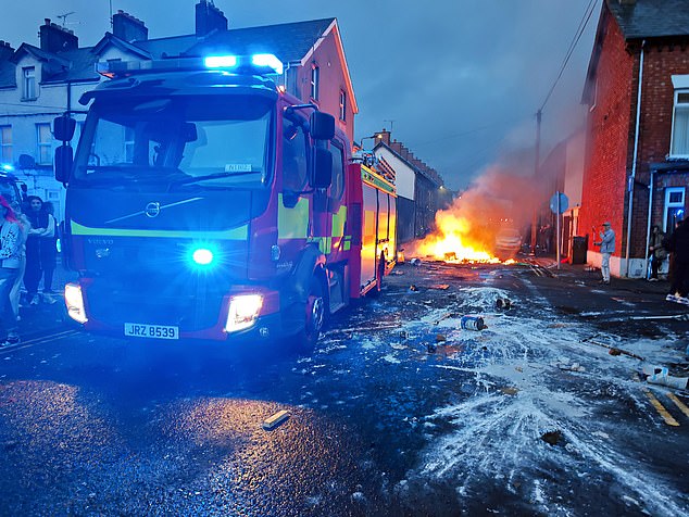 A fire engine appears at the scene to put out the fires created during the riots last night