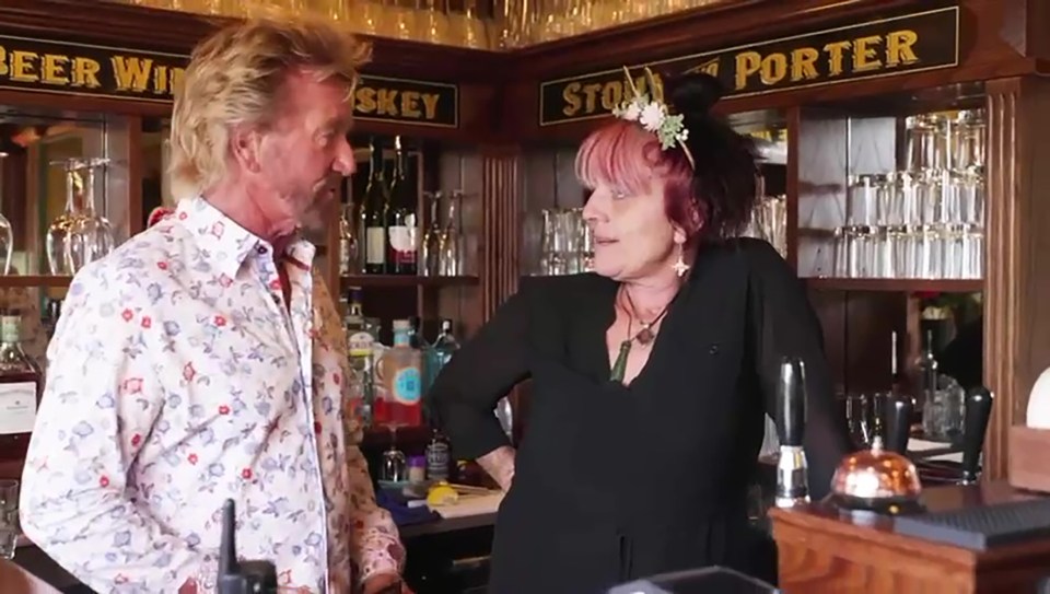 Noel Edmonds and a woman at a bar.