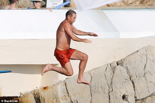 Manager of Coventry City Frank showed off his tanned and toned physique in a pair of bright orange swim shorts as he enjoyed his time off after the football season