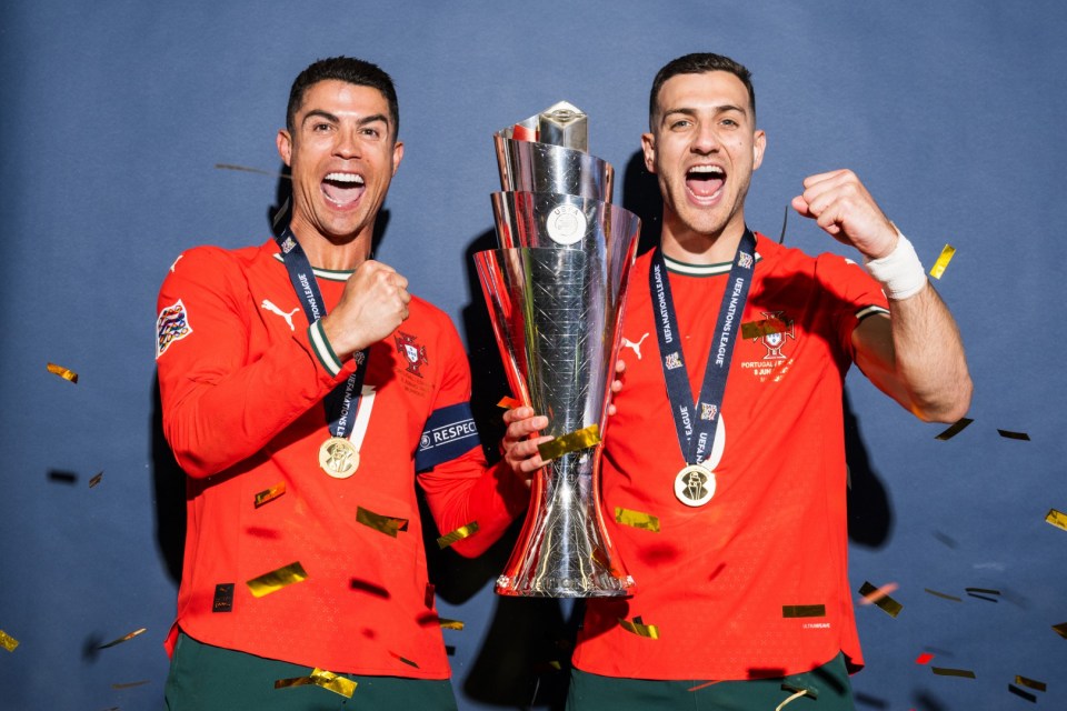 MUNICH, GERMANY - JUNE 08: Cristiano Ronaldo and Diogo Dalot of Portugal pose for a photo with the UEFA Nations League trophy during the official UEFA Nations League 2025 Winners' shoot after the UEFA Nations League Final between Spain and Portugal at Munich Football Arena on June 08, 2025 in Munich, Germany. (Photo by Sebastian Widmann - UEFA/UEFA via Getty Images)