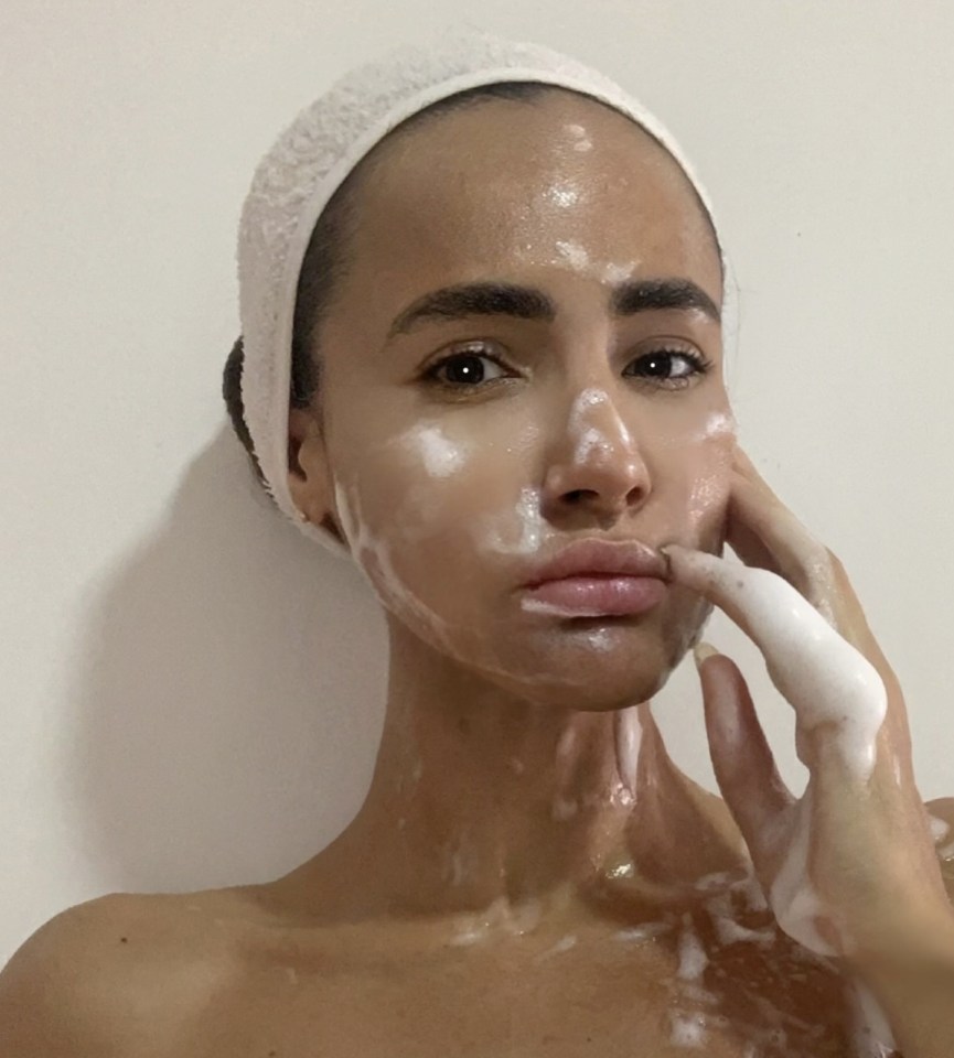 Woman applying face cream.