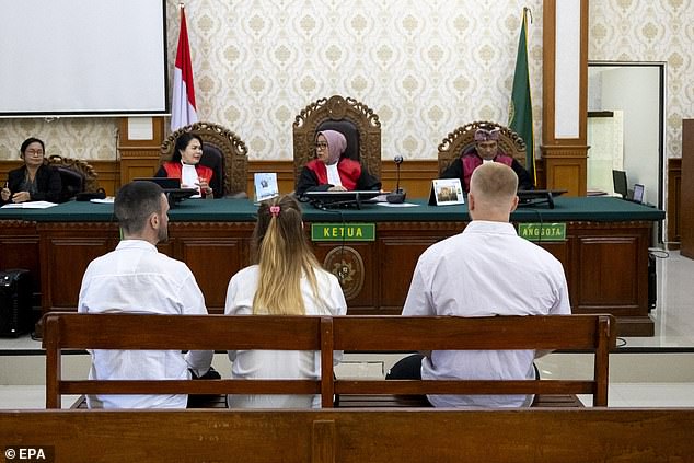 The group were pictured listening to a judge during their court appearance today