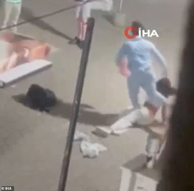 A woman was knocked to the ground by one of the Brits as they scrapped in the street