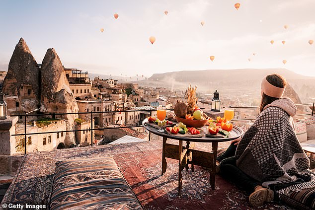 Breakfast on a rooftop in Cappadocia at sunrise. Many rooms have balconies overlooking the fairy chimneys