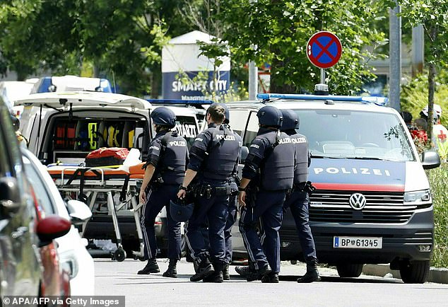Policemen are seen in a street close to a school where, according to reports, several people died in a shooting, on June 10, 2025 in Graz